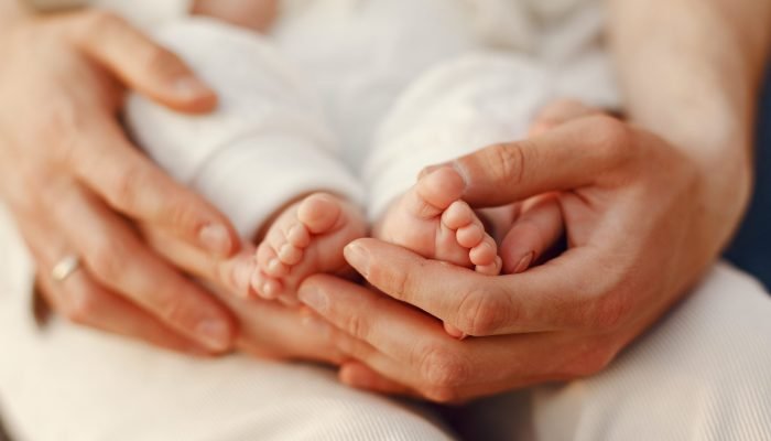 Parents with daughter. Family in a park. Newborn girl.