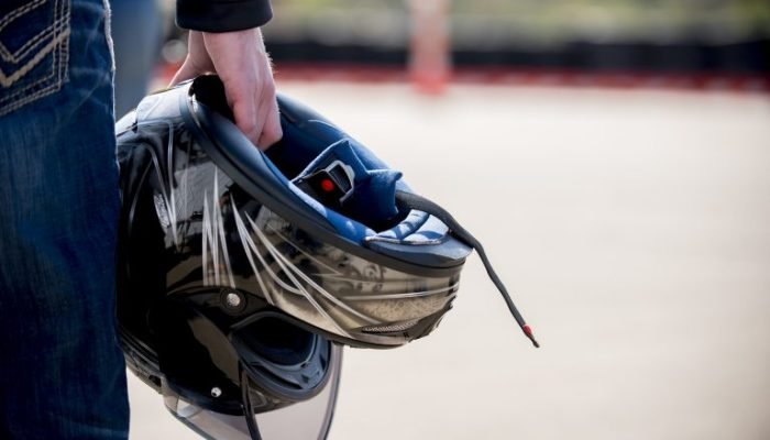closeup-shot-male-holding-his-motorcycle-helmet-with-blurred-distance-768x513