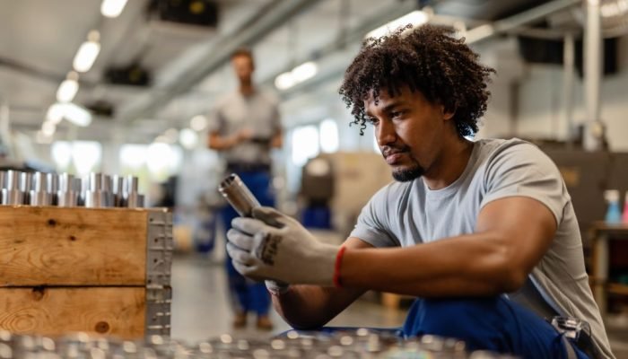 young-black-worker-examining-stainless-steel-cylinder-rod-while-working-distribution-warehouse-1024x683